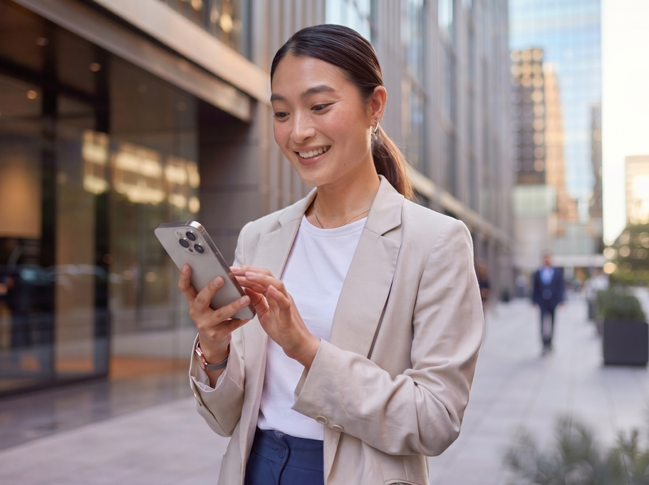 スマートフォンを見ながら満足気な表情の女性